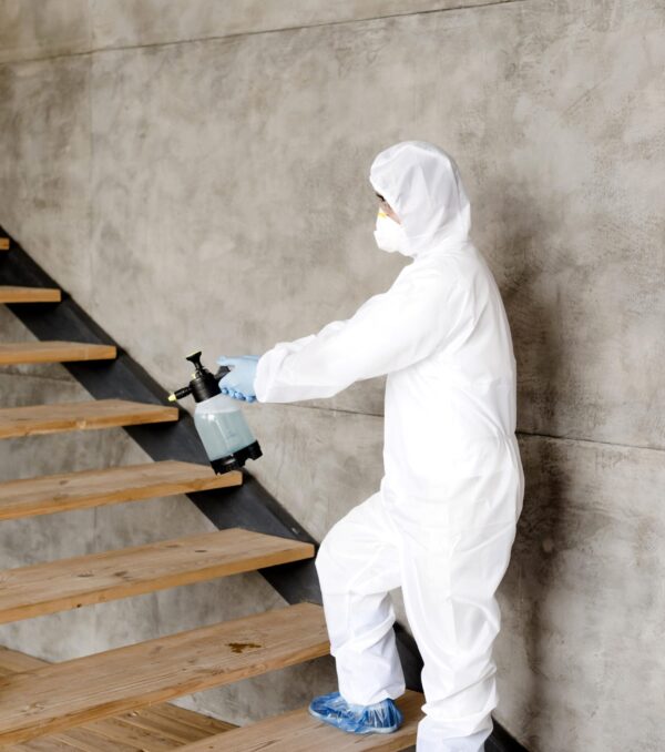 side-view-man-disinfecting-stairs side-view-man-disinfecting-stairs